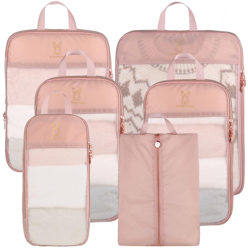 Set of pink See Through Expandable Compression Packing Cubes with various sizes designed for lightweight travel organization and easy visibility